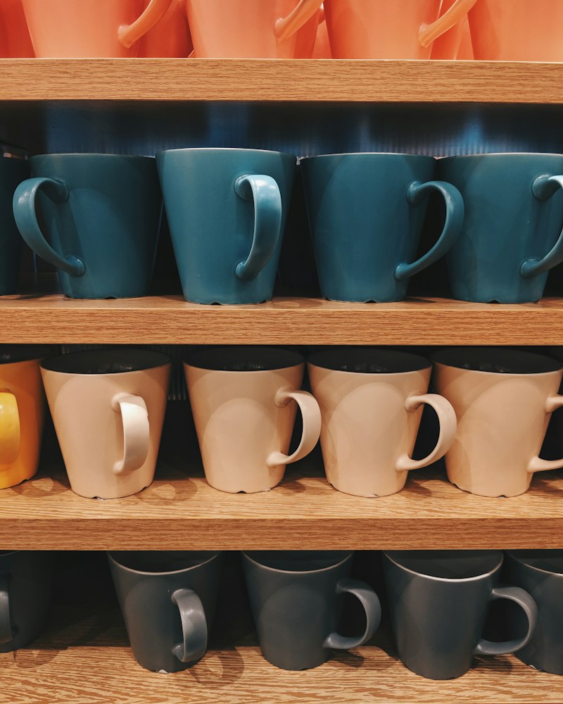 Assorted ceramic mugs on a shelf